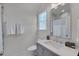 Clean bathroom featuring a vanity, decorative mirror, and tile shower with white curtain at 2306 Byrd St, Raleigh, NC 27608