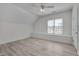 Neutral bedroom featuring wood floors, a large window, and white walls with minimal decor at 2306 Byrd St, Raleigh, NC 27608