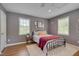 Comfortable bedroom with neutral tones, hardwood floors, natural light, and ample closet space at 2306 Byrd St, Raleigh, NC 27608
