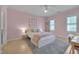 Bright pink bedroom with a plush rug, ceiling fan and large windows providing ample natural light at 2306 Byrd St, Raleigh, NC 27608