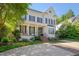 Stunning white brick two-story home with black shutters, a covered porch, and professional landscaping at 2306 Byrd St, Raleigh, NC 27608