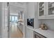 Bright, modern kitchen with white cabinetry, stainless steel appliances, and a view to the outdoor patio at 2306 Byrd St, Raleigh, NC 27608