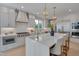 Elegant kitchen features white cabinets, marble countertops, stainless appliances, and a stylish island with seating at 2306 Byrd St, Raleigh, NC 27608