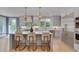 Bright, modern kitchen with white cabinets, stainless steel appliances, island seating, and gold accents at 2306 Byrd St, Raleigh, NC 27608
