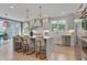 Modern kitchen with white cabinets, marble countertops, stainless steel appliances, and island seating at 2306 Byrd St, Raleigh, NC 27608