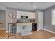 Cozy kitchenette featuring white cabinets, stainless steel appliances, and wood-look flooring at 2306 Byrd St, Raleigh, NC 27608