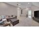 Open living room featuring a sectional couch, ottoman, and access to the upstairs area at 2306 Byrd St, Raleigh, NC 27608