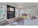 Cozy living room featuring hardwood floors, fireplace, chandelier, and open layout to kitchen at 2306 Byrd St, Raleigh, NC 27608