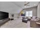Spacious living room with ample seating, large television, and a ceiling fan to circulate air at 2306 Byrd St, Raleigh, NC 27608