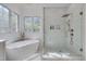 Elegant bathroom with free-standing tub, rainfall shower, and abundant natural light at 2306 Byrd St, Raleigh, NC 27608