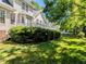 Beautiful backyard with a well-manicured lawn, mature trees, and a white deck at 2405 Flints Pond Cir, Apex, NC 27523