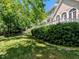 Well maintained lawn with mature trees create a park-like atmosphere in this home's backyard at 2405 Flints Pond Cir, Apex, NC 27523