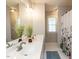 Well-lit bathroom with double sinks, a large mirror, and a shower with floral curtain at 2405 Flints Pond Cir, Apex, NC 27523
