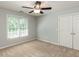 Cozy bedroom featuring neutral carpeting and a ceiling fan for added comfort at 2405 Flints Pond Cir, Apex, NC 27523