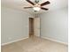 Spacious bedroom with neutral carpet, a ceiling fan, and a door to another room at 2405 Flints Pond Cir, Apex, NC 27523