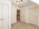 Bedroom with neutral carpet, doors, access to the upstairs and a modern light fixture at 2405 Flints Pond Circle Cir, Apex, NC 27523