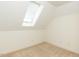 Cozy bedroom with neutral carpet and a skylight, providing ample natural light at 2405 Flints Pond Cir, Apex, NC 27523