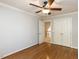Bright bedroom with hardwood floors, a ceiling fan, and double door closet at 2405 Flints Pond Cir, Apex, NC 27523
