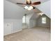Expansive bonus room with dormer windows and carpet, illuminated by ceiling fans and natural light at 2405 Flints Pond Cir, Apex, NC 27523