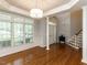 An empty dining room has wood floors and large windows at 2405 Flints Pond Cir, Apex, NC 27523