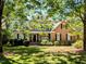 Charming two-story home featuring a welcoming front porch and a well-manicured lawn at 2405 Flints Pond Cir, Apex, NC 27523