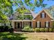 Charming two-story home featuring a welcoming front porch and a well-manicured lawn at 2405 Flints Pond Cir, Apex, NC 27523