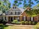 Charming two-story home featuring a welcoming front porch and a well-manicured lawn at 2405 Flints Pond Cir, Apex, NC 27523