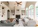 Staged living room features built-ins, fireplace, and arched windows offering natural light at 2405 Flints Pond Cir, Apex, NC 27523