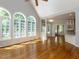 Bright living room features hardwood floors, arched windows, and an open floor plan at 2405 Flints Pond Cir, Apex, NC 27523