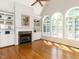 Inviting living room features a fireplace, built-in cabinets, and large arched windows at 2405 Flints Pond Cir, Apex, NC 27523