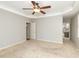 Spacious main bedroom with neutral carpet, a ceiling fan, and an ensuite bathroom at 2405 Flints Pond Cir, Apex, NC 27523