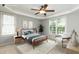 Cozy main bedroom with a ceiling fan, tray ceilings and lots of natural light at 2405 Flints Pond Cir, Apex, NC 27523