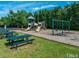 Community playground with swings, slides, picnic tables, and benches at 2405 Flints Pond Cir, Apex, NC 27523