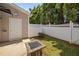 Small backyard with a concrete patio, fire pit and a white wooden fence at 2609 Asher View Ct, Raleigh, NC 27606