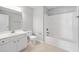Bright bathroom with white vanity, tiled shower and tub combination at 2609 Asher View Ct, Raleigh, NC 27606