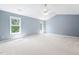 Large bedroom features neutral carpet, vaulted ceiling, and bright windows at 2609 Asher View Ct, Raleigh, NC 27606