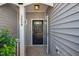 Covered porch with view of a black front door with glass, side panel and black door hardware at 2609 Asher View Ct, Raleigh, NC 27606