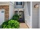 Inviting entryway to a townhome with a decorative door and manicured bushes for added curb appeal at 2609 Asher View Ct, Raleigh, NC 27606