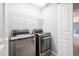 Modern laundry room with stainless steel washer and dryer at 2609 Asher View Ct, Raleigh, NC 27606