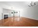 Spacious living room with hardwood floors, fireplace, large windows, a fan, and a modern chandelier at 2609 Asher View Ct, Raleigh, NC 27606