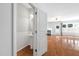 View of the living room with hardwood floors, fireplace, and powder room at 2609 Asher View Ct, Raleigh, NC 27606