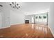Inviting living room with fireplace, hardwood floors, chandelier and natural light from the large windows at 2609 Asher View Ct, Raleigh, NC 27606