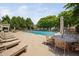 Community pool area showcasing lounge chairs and outdoor tables with umbrellas at 2609 Asher View Ct, Raleigh, NC 27606