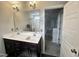 Bathroom featuring a double vanity, a large mirror, and a shower-tub combo at 267 Darecrest Ln, Wendell, NC 27591