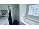 Bathroom featuring a soaking tub with decorative window, separate shower with glass door, and modern fixtures at 267 Darecrest Ln, Wendell, NC 27591