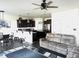 Open-concept living room and kitchen with hardwood floors, recessed lighting, and a ceiling fan for comfortable living at 267 Darecrest Ln, Wendell, NC 27591
