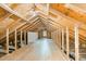 Unfinished attic space features exposed beams and subflooring, offering potential for customization at 2913 Escondido Farm Rd, Garner, NC 27529