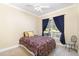 Comfortable bedroom with plush carpeting, a ceiling fan, and a large window providing natural light at 2913 Escondido Farm Rd, Garner, NC 27529