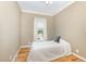 Small bedroom featuring hardwood floors, a window, and a soft bed at 2913 Escondido Farm Rd, Garner, NC 27529