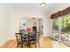 Bright dining area featuring hardwood floors, slider door access to the backyard, and an open view to the living room at 2913 Escondido Farm Rd, Garner, NC 27529